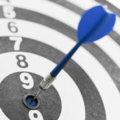 Red dart target arrow hitting on bullseye, Metaphor to target marketing and business success concept